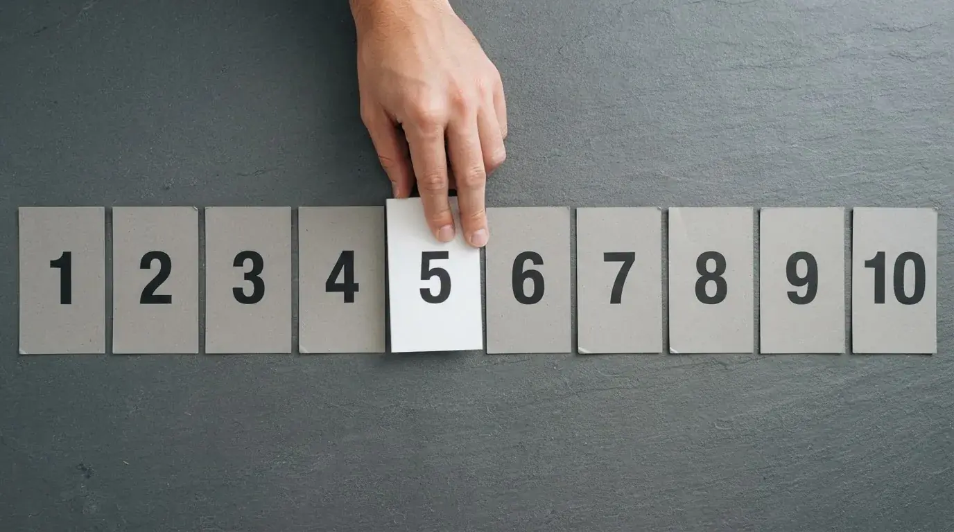 overhead flat-lay of a hand ranking printed casino logos on numbered cards on a desk